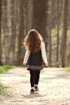A little girl walking in the woods