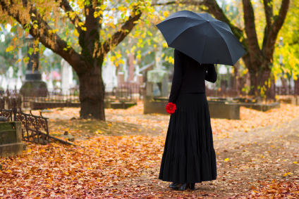 Woman in Mourning at Cemetery in Fall