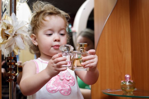 child with perfume bottles