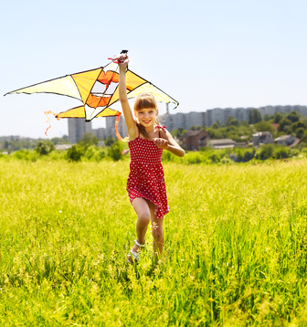 Child flying kite outdoor.